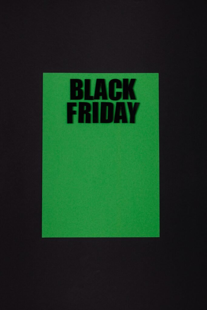 Green paper on black background with bold 'Black Friday' text for sales promotion.